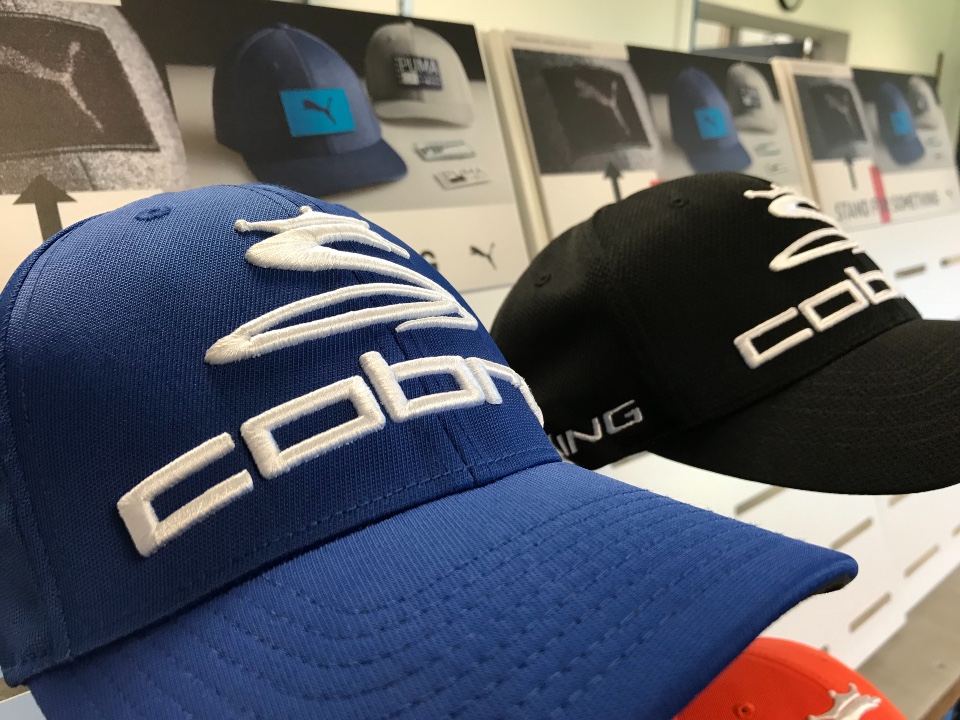 Cobra Puma Golf caps and belts displays 1